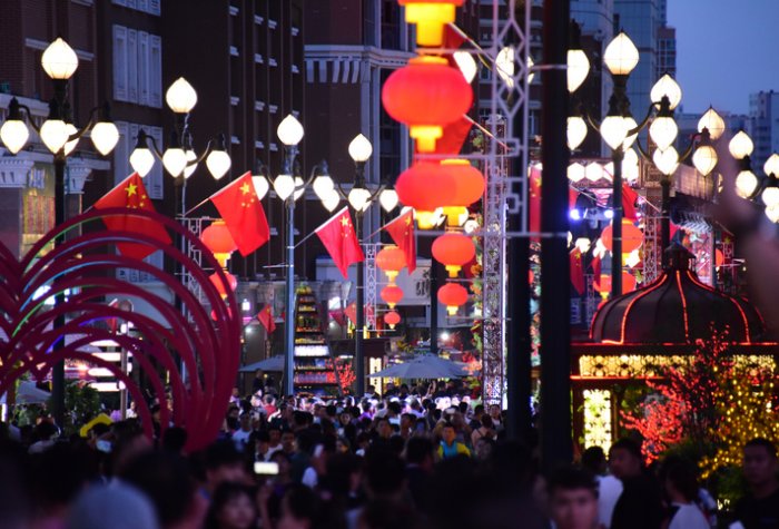 Chinese flag and lanterns on a street in China.