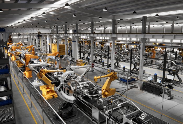 Factory with lines of robots performing tasks.