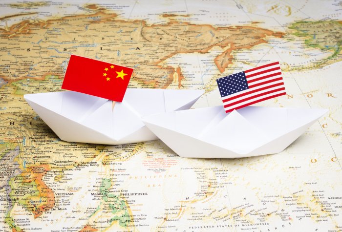 Paper boats with Chinese and American flags