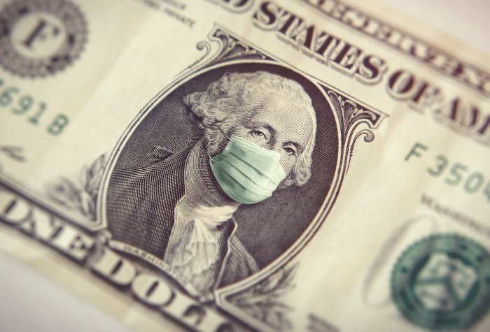 A dollar bill and mask represents the economy during COVID-19 pandemic.