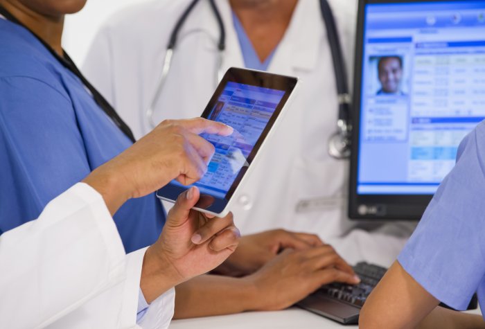 Health-care providers looking at electronic medical records