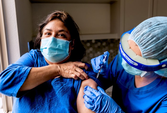 Woman gets vaccinated.