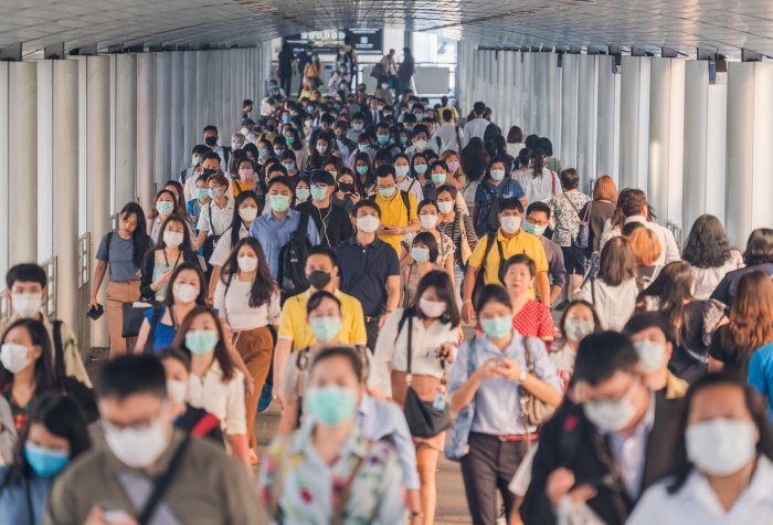 A crowd of people walk in a subway station in Wuhan, China.