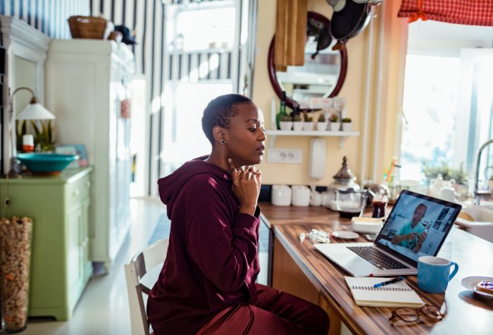 A woman gets a consultation through telemedicine call with physician.