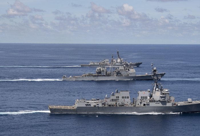 U.S. Navy and Indian Navy ships steam in formation in the Indian Ocean.