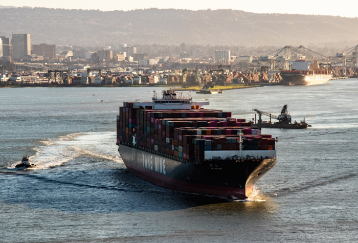 A loaded shipping liner sails out of port.