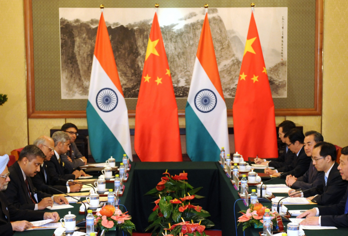 Chinese President Xi Jinping (R) talks with India's Prime Minister Manmohan Singh (L) during a meeting at the Diaoyutai State Guesthouse in 2013.