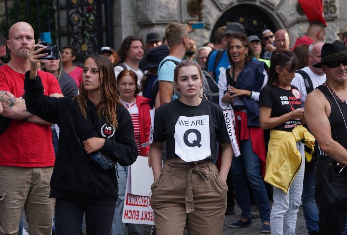 Mostly right-wing protesters, including a young woman wearing a QAnon shirt, in Berlin