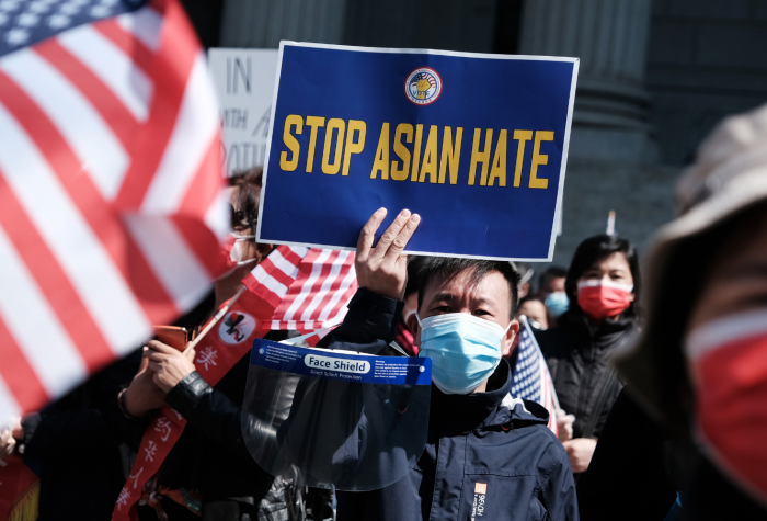 A man holds a 'Stop Asian Hate' sign during a rally protesting rising violence against Asian Americans.