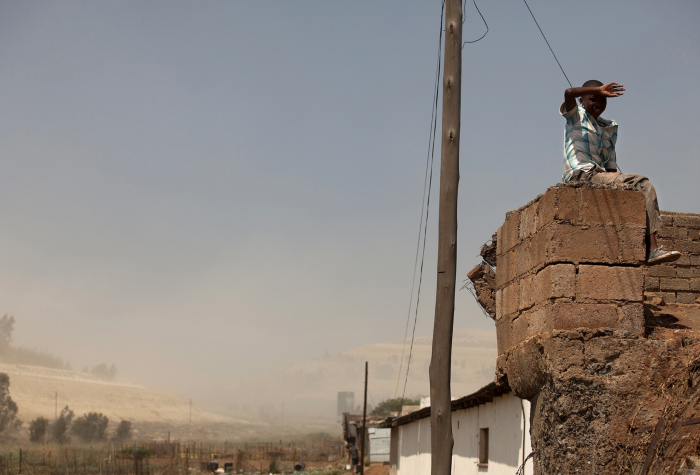 A boy sitting on a roof
