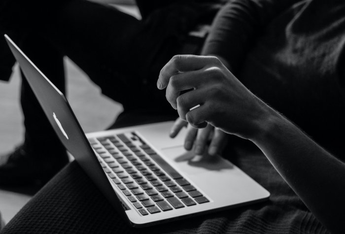 image of hands typing on a laptop