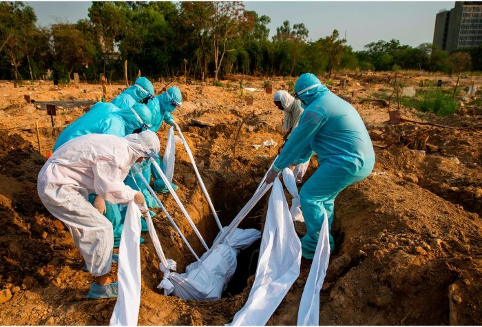 People in suits burying a body