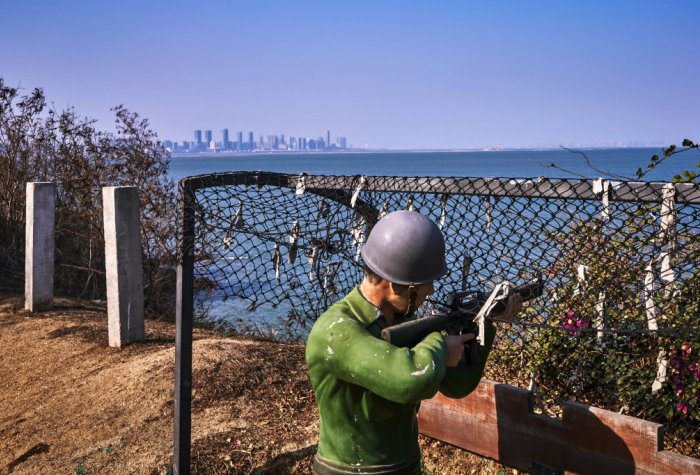 Figures of Kuomintang soldiers are seen in the foreground, with the Chinese city of Xiamen in the background, on February 04, 2021 in Lieyu, an outlying island of Kinmen that is the closest point between Taiwan and China.