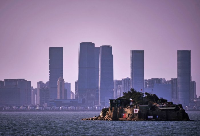 An Island that lies inside Taiwan's territory is seen with the Chinese city of Xiamen in the background.