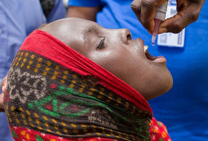 A child receives a polio vaccine in Africa.