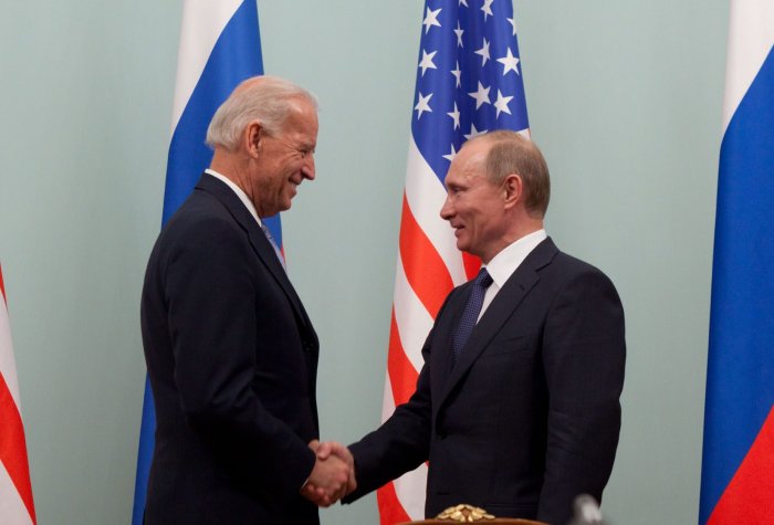 Joe Biden shaking hands with Vladimir Putin