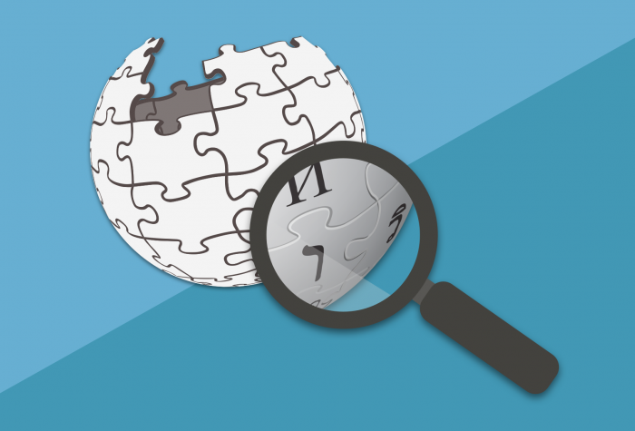 magnifying glass hovering over Wikipedia logo