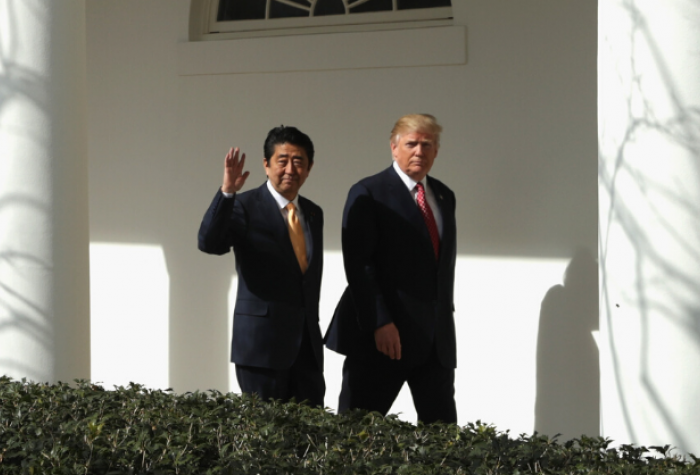 Prime Minister Shinzō Abe of Japan and President Donald Trump of the United States walk alongside the White House in Washington D.C.