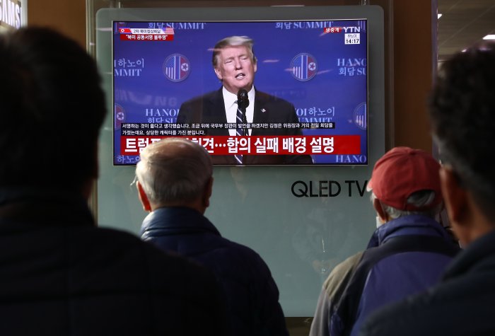 South Koreans watch TV screen reporting on the U.S. President Donald Trump press conference at Seoul Railway Station on February 28, 2019 in Seoul, South Korea