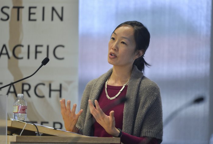 A young woman speaking at a podium