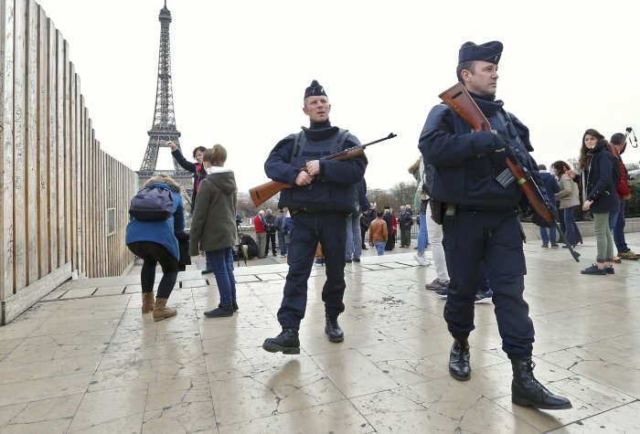 Police patrol near the Eiffel Tower the day after a series of deadly attacks in Paris.