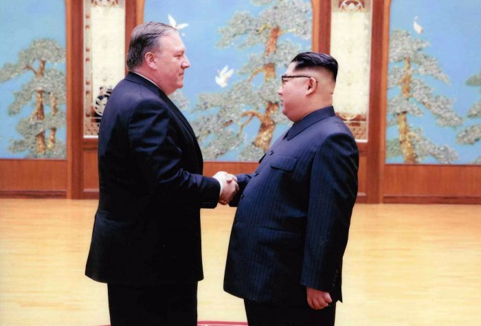 Secretary of State Mike Pompeo shakes hands with North Korean leader Kim Jon-un
