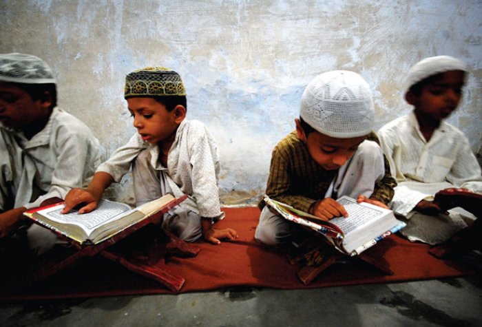 Muslim children read the Quran at an Indian madrassa. india muslim children tehelka