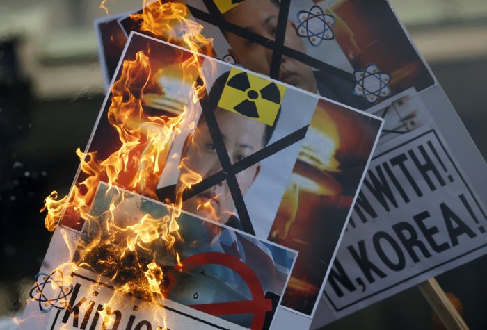 A protester burns banners depicting North Korean leader Kim Jong-un during an anti-North Korea rally in central Seoul, South Korea, January 7, 2016. A protester burns banners depicting North Korean leader Kim Jong-un during an anti-North Korea rally in central Seoul, South Korea, January 7, 2016.
