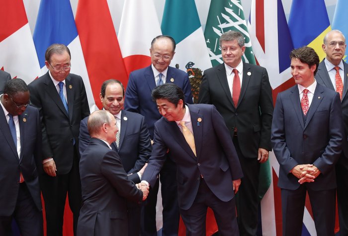 Japanese Prime Minister Shinzo Abe shakes hands with Russian President Vladimir Putin at the G20 Summit on Sept. 4, 2016, Hangzhou, China. | Photo credit: Lintao Zhang/Getty Images Japanese Prime Minister Shinzo Abe shakes hands with Russian President Vladimir Putin at the G20 Summit on Sept. 4, 2016, Hangzhou, China. | Photo credit: Lintao Zhang/Getty Images