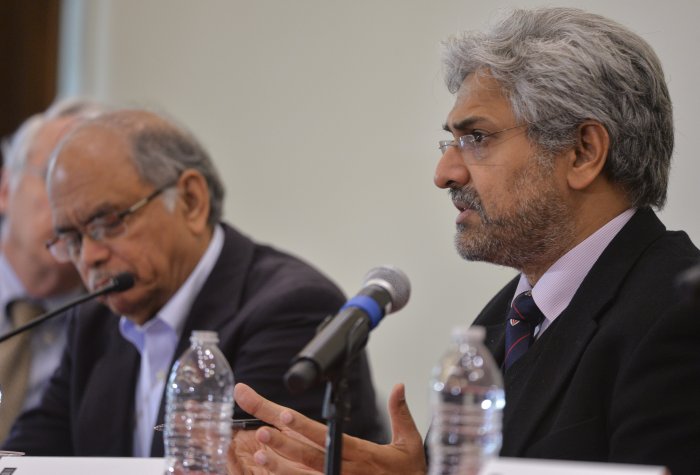 Siddharth Varadarajan speaking on a panel, seated next to Nayan Chanda.