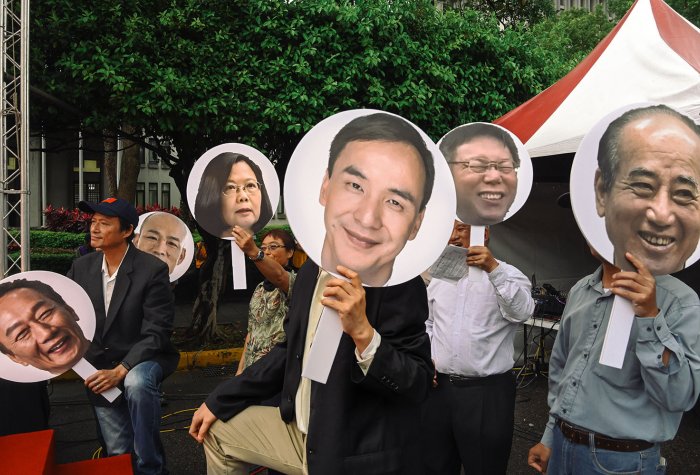 People hold pictures of Taiwanese presidential candidates People hold pictures of Taiwanese presidential candidates