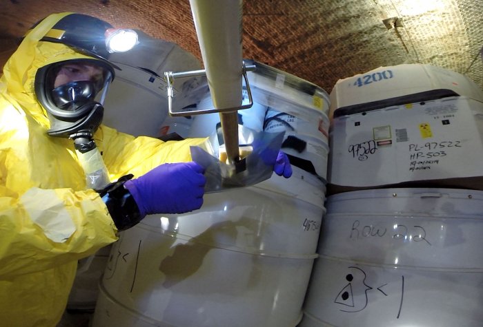A recovery worker obtains samples from a damaged drum after a radioactive leak at the Waste Isolation Pilot Plant in Carlsbad, New Mexico in May, 2014. A recovery worker obtains samples from a damaged drum after a radioactive leak at the Waste Isolation Pilot Plant in Carlsbad, New Mexico in May, 2014.