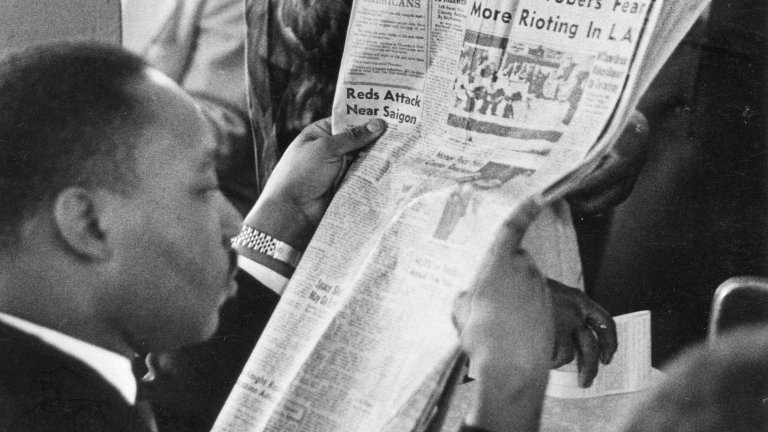 Martin Luther King reading paper