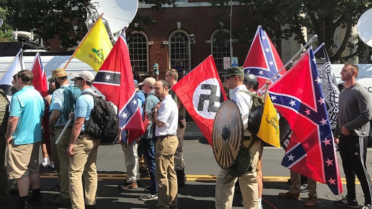 White supremacists carrying Confederate flags and Gadsen flags during the Unite the Right Rally in Charlottesville, Virginia