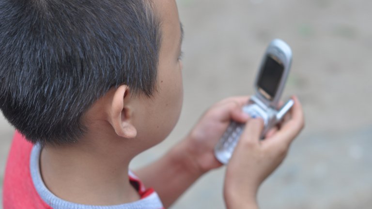 REAP boy on phone