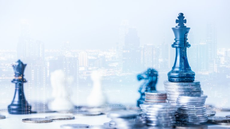 Double exposure image of the coin stack which has the Staunton chess set such as king on top and overlay with cityscape image. The concept of economy, investment, and competition.