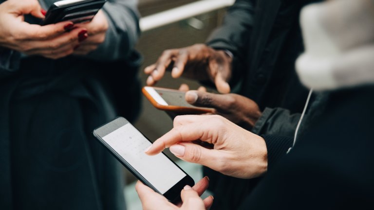 hands holding phones