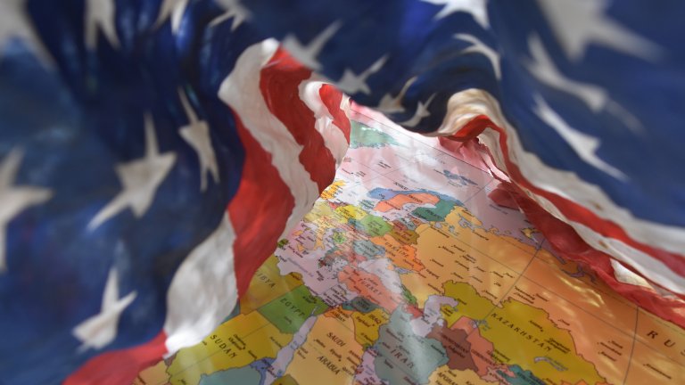 U.S. flag on top of a world map