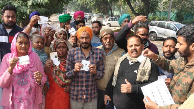 Voters protest outside a polling station at Phase 9 during the Punjab Municipal Election at St Soldier School on February 14, 2021 in Mohali, India.