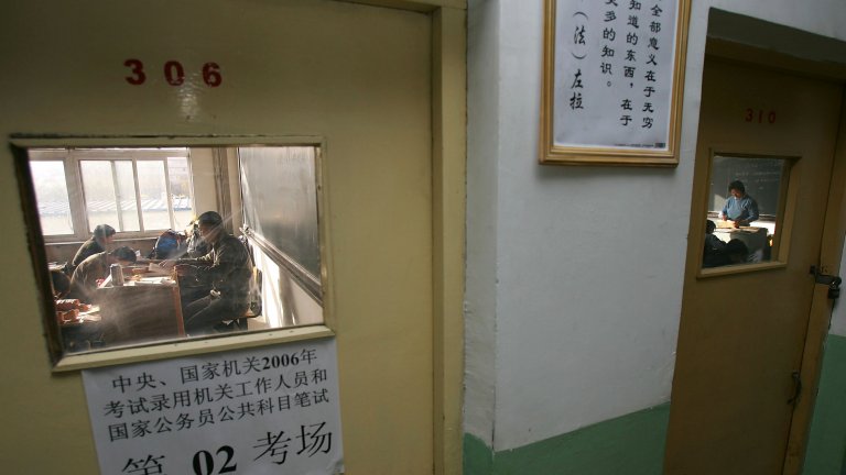 A group of people behind a closed door taking the national civil servant qualification exam in Beijing. A group of people behind a closed door taking the national civil servant qualification exam in Beijing.