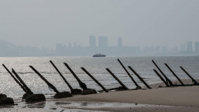 he Chinese city of Xamen is seen in the distance behind aged anti-landing barricades on a beach facing China on the Taiwanese island of Kinmen which, at points lies only a few miles from China, on April 19, 2018 in Kinmen, Taiwan.