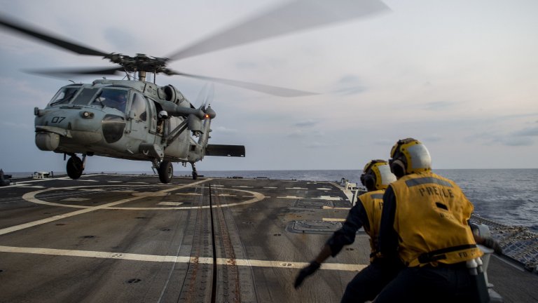 U.S. Navy seaman directs an MH-60S Sea Hawk while landing on the flight deck of the guided-missile destroyer USS Preble during deck landing qualifications in support of Exercise Balikatan in the South China Sea, April 6, 2019. U.S. Navy Boatswain’s Mate Seaman Louie Beasley, Jr., from Oklahoma City, directs an MH-60S Sea Hawk, assigned to Helicopter Sea Combat Squadron (HSC) 25, while landing on the flight deck of the guided-missile destroyer USS Preble (DDG 88) during deck lan